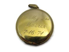 "A lovely vintage gold locket. It's 12kt gold fill, and has etched flowers and flourishes on the front. Inside there two spots for photos. On the back, it reads \"To My 2nd Mother 7-16-71\". Marked \"1/20 12kt GF\". Measures about 1.5\" across and has minor wear appropriate for age (some small scratches). The photo frame inside is bent. I am always happy to answer any questions or send more photos when needed. Thanks for shopping Vintage In Bloom! www.facebook.com/vintageinbloom More pendants &a Vintage Memorial Locket Necklace For Mother's Day, Victorian Engraved Locket Necklace For Memorials, Antique Engraved Jewelry For Mother's Day, Vintage Stamped 14k Locket Necklace For Wedding, Vintage 14k Stamped Locket Necklace For Wedding, Vintage Yellow Gold Memorial Locket Necklace, Antique 14k Stamped Locket Necklace For Anniversary, Vintage Gold Locket Necklace Stamped 14k, Vintage Yellow Gold Locket Necklace For Memorial