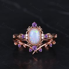 an opal and amethorate ring set with purple sapphires on the sides