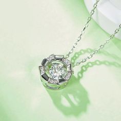 An eye-catching round moissanite dances with ease at the center of this appealing women's necklace, expressing your unstoppable love. Additional round gem set in sterling silver frame the center. Features Moissanite was originally found in meteorites(Chemical name: Silicon Carbide). It was first discovered in 1893, while a scientist was examining meteor samples from a crater in Arizona. After many years, the experts has been recreated moissanite in the laboratory, that make the gemstone with fri Luxury Silver Necklace With Round Stone, Silver Round Diamond Necklace With Halo, Diamond White Solitaire Necklace With Cubic Zirconia, Silver Diamond Solitaire Necklace With Round Pendant, Round Moissanite Solitaire Necklace With Halo Setting, Silver Moissanite Round Diamond Necklace, Silver Round Diamond Necklace With Halo Setting, Silver Round Necklace With Halo Design, Diamond White Solitaire Necklace With Halo Design