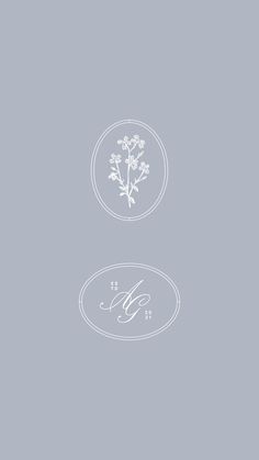 two white flowers are in the middle of a gray background with an oval frame and monogram