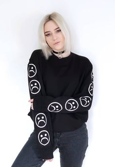 "Sad Emoticons Sweatshirt. High-quality unisex sweatshirt with a very recognizable print of our own design. Available in black and white. The model is 168 cm (5'6\") tall and has size L on. JOIN US ON INSTAGRAM 🌹 http://instagram.com/blvck.pl 🏷 PRODUCT DETAILS 🏷 Hand-printed Unisex 80% High-quality Cotton 20% Polyester Made in Poland 📏 SIZING & FIT 📏 All our sweatshirts and T-shirts are unisex. Measurements (width/length) S - 50/64 cm (19.5\"/25\") M - 54/66 (21\"/26\") L - 58/68 (22.5\ Emo Crew Neck Sweatshirt For Streetwear, Emo White Tops With Letter Print, White Emo Style Top With Letter Print, White Emo Tops With Letter Print, White Emo Top With Letter Print, Edgy Long Sleeve T-shirt With Screen Print, White Emo Streetwear Tops, White Emo Crew Neck Top, Emo Letter Print Sweatshirt For Streetwear