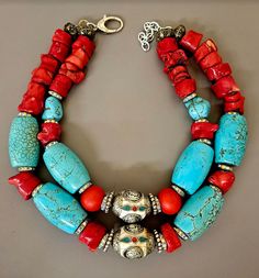 Big, bold, chunky and heavy all aptly describe this one-of-a-kind oversized beaded tribal - ethnic statement necklace. Featuring two inlaid Tibetan resin focal beads, this is primarily comprised of turquoise blue magnesite barrel beads, red branch coral nuggets, silver aurora borealis rhinestone rondelles and silver tone metal daisy spacers. The very back is finished with ornate copper beads. Adjusts from 18-20" but fits more like 17-19" given the size of the beads. Closes with silver tone hardw Bold Necklace, Focal Beads, Red Necklace, Coral Necklace, Focal Bead, Turquoise Color, Red Coral, Leather Chain, Statement Jewelry