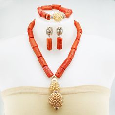 Main Material: Coral  Length: 19 inch Items included: Necklace / Bracelet / Earring Packing: 1 necklace + 1 bracelet + earring (1 pair) All items are by handmade, it need to takes about 5-7 days to make it . Make a bold statement on your wedding day with our exquisite African coral bead jewelry set. This traditional set is designed to enhance your bridal attire and add a touch of cultural elegance. Bohemian Hand-strung Pearl Jewelry, Orange Faceted Beads Jewelry, Gold Bead Dangle Jewelry For Jewelry Making, Adjustable Coral Beaded Jewelry, Dangle Pearl Jewelry With Gold Beads, Dangle Pearl Earrings With Gold Beads, Pearl Dangle Jewelry With Gold Beads, Costume Jewelry With Faceted Dangle Beads, Gold Beaded Dangle Jewelry For Gifts