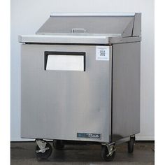 a stainless steel trash can on wheels with the door open