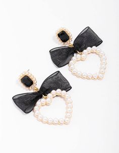 For a decorative addition to your stack, style these gold-toned drop earrings. These unique statement earrings feature a heart-shaped silhouette, dotted with pearls and adorned with a black ribbon for a coquette-inspired finish. Dimensions: Length 50mm x Width 30mm Backing Type: Post Back Weight: 13.32g | Lovisa Gold Pearl Bow Heart Drop Earrings, Black Pearl Bow, Heart Drop Earrings, Earrings Black, Black Ribbon, Gold Pearl, Statement Earrings, Dots, Ribbon, Drop Earrings