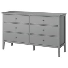 a gray dresser with six drawers and two legs