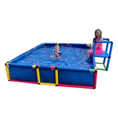 two children are playing in the water on a blue trampoline with ladders