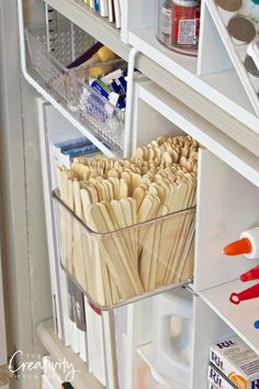 an organized refrigerator with toothbrushes and other items