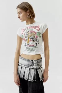 Baby tee with a Les Tigres printed at the front. Hits at the waist in a cropped silhouette with a crew neckline and cap sleeves. Find it exclusively at Urban Outfitters. Features: - Les Tigres graphic baby tee - Tee with a Les Tigres graphic at the front - Cropped silhouette - Crew neckline - UO exclusive Content + Care: - 100% Cotton - Machine wash - Imported Size + Fit: - Model in White is 5’10' and wearing size Small - Measurements taken from size Small - Chest: 24' - Length: 17' Fitted Cropped T-shirt With Logo Print, Logo Print Cropped T-shirt For Spring, Cropped Logo Print T-shirt For Spring, Spring Cropped T-shirt With Logo Print, Vintage Cropped T-shirt With Graphic Print For Summer, Fitted Cotton Cropped T-shirt With Graphic Print, Fitted Logo Print Crop Top For Summer, Fitted Graphic Tee From Urban Outfitters, Vintage Graphic Print Top From Urban Outfitters