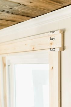 the measurements for a window frame are shown in front of a window with wooden slats