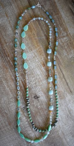 My seafoam collection celebrates the mystical place where sea meets sky and land. This beauty is 60 inches long and features amazonite and blue fire agate gemstones, deep green freshwater pearl, crystal, Czech glass and sterling silver. Wear it long, doubled, tripled, or knotted in oh so many ways. Wolf Designs, Vintage Jewelry Ideas, Wooden Bead Necklaces, Freshwater Pearl Jewelry, Gemstone Beaded Necklace, Hippie Necklace, Long Beaded Necklace, Tassel Jewelry, Fire Agate