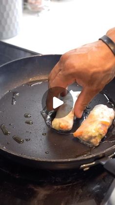 a person is frying some food in a skillet