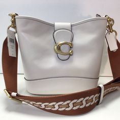 Nwt Coach Tali Leather Bucket/Shoulder Bag Color: Chalk (White) Style: Ca112 Leather Zippers And Magnetic Closures Fabric Lining Interior Snap Button Pocket Four Protective Feet At Base Removable Shoulder Strap For Shoulder Or Crossbody Carry Includes Interchangeable Strap Approx. 10.75" W X 8.75" H X 5" W Bag; 21.5" Strap; 23.5" Webbing Drop Luxury White Shoulder Bag With Adjustable Strap, Designer White Leather Shoulder Bag, Cream Bucket Satchel With Detachable Strap, White Top Handle Bucket Bag For Travel, Tote Shaped Bucket Bag For Errands, Classic Cream Bucket Bag With Gold-tone Hardware, Cream Bucket Bag With Detachable Strap, White Leather Satchel With Gold-tone Hardware, Cream Bucket Bag With Detachable Strap For Errands