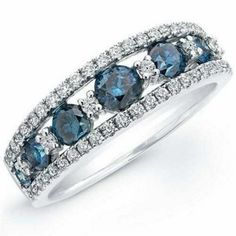 three stone ring with blue and white diamonds on the sides, set in 18k white gold