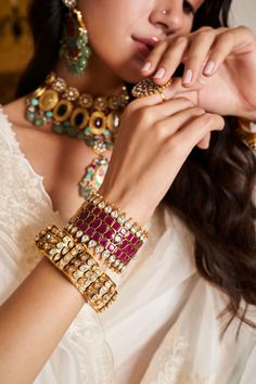 Step into refined elegance with the Sadhika kundan bangles, a perfect blend of tradition and contemporary style. These bangles showcase exquisite kundan craftsmanship, featuring intricate designs that shimmer with every movement. Ideal for festive occasions, they add a touch of regal charm to your outfit, ensuring you stand out with grace and sophistication. Elegant Chandbalis With Cutdana For Designer Wear, Designer Wear Festival Chandbalis, Kundan Chandbalis With Tilla For Designer Wear, Designer Kundan Chandbalis With Tilla Detail, Bollywood Style Designer Jewelry With Gota Work, Fusion Style Cutdana Bangle For Festivals, Fusion Meenakari Bangle For Festivals, Hand Set Kundan Bollywood Bangle, Bollywood Kundan Bangle With Hand Set