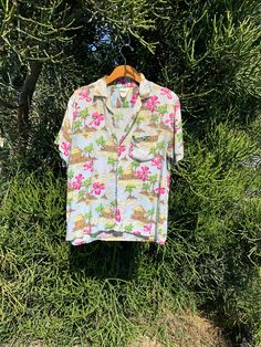 Vintage Hawaiian shirt aloha tiki wear By California Rainbow 🌈  ⭐️signs of wear and a bit of color bleeding in a few different spots, adds to its authentic vintage worn feel ⭐️ Size tag has faded  I've provided pictures in listing with measurements, click on pictures to enlarge & see details.  pictures with measurements so you can see exactly where measurements are taken.  Click on pictures to enlarge,  For circumference, double listed measurements. Check measurements on listing carefully. Compare against a piece of clothing that fits you well. Keep in mind Vintage sizes run differently than modern sizes, so check measurements.  ⭐️I apologize, however I do not accept any returns, all sales are final ⭐️ Ask questions, I answer quickly during shop hours 8am-8pm  🌟 Please note that  items a Hawaiian Short Sleeve Shirt With Floral Print For Summer, Hawaiian Camp Shirt With Graphic Print For Vacation, Hawaiian Style Graphic Print Short Sleeve Beach Shirt, Hawaiian Style Graphic Print Short Sleeve Shirt For Beach, Hawaiian Graphic Print Camp Shirt For Beach Season, Hawaiian Short Sleeve Shirt With Graphic Print For Beach, Hawaiian Short Sleeve Beach Shirt, Vintage Cotton Hawaiian Shirt For Summer, Summer Beach Camp Shirt With Short Sleeves