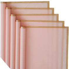 five pink sheets with gold trim on them