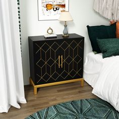 a bedroom with a black cabinet and green pillows