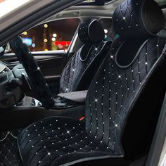 the interior of a car is decorated with black diamond studded fabric and leather seats