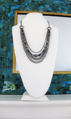 "Multi Strand Grey and Gunmetal Beaded Necklace, handmade by Ralston Originals. This beaded necklace includes a collection of beautiful crystal, glass, metal, and acrylic beads, in grey, silver, and black. The chain is gunmetal, and has multi strands of 4 different sizes and types of chain. This beaded necklace is 32 inches long, has a lobster clasp, and 3 inch extension chain. This black and grey beaded necklace is ready to send today, and it includes free shipping in the USA. I carefully packa Silver Hematite Necklace With Gemstone Beads, Metal Beaded Necklaces With Round Beads, Metal Beaded Necklace Costume Jewelry, Silver Faceted Beads Metal Beaded Necklaces, Silver Metal Beaded Necklace With Faceted Beads, Beaded Metal Necklaces With Round Beads, Metal Necklaces With Round Beads For Jewelry Making, Metal Faceted Beads Costume Necklaces, Costume Jewelry Metal Necklaces With Faceted Beads