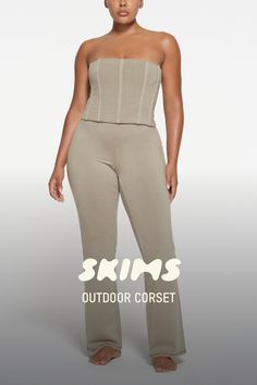 Elevate your off-duty look in this comfortable corset that shapes your figure with flexible boning. Features a worn-in look and exposed back zipper. Pair with the Outdoor High Waist Legging for a flattering set. Fits true to size. This garment has undergone a special wash process which may result in variations in shading and color. These variations are intentional and add to the unique characteristics of this garment. The coloring may rub off on light colored fabrics and upholstery. Wash before Beige Strapless Corset With Corset Back, Trendy Stretch Corset With Built-in Bra, Sculpting Shapewear Corset With Built-in Bra, Beige Corset With Built-in Bra For Summer, Beige Fitted Corset With Built-in Bra, Corset Top, Off Duty, High Waisted Leggings, Zipper