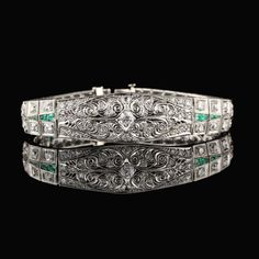 Stunning antique platinum bracelet with old european cut diamonds and emeralds. Item #B0024 Metal: Platinum Weight: 29.3 Grams Total Diamond Weight: Approximately 5.50 cts Diamond Color: H Diamond Clarity: VS2 - SI1 Measurements: 7 in x 5.5 mm Layaway: For your convenience, we will be happy to provide layaway payment options. Please contact us to work out a layaway plan which best suits your needs. All layaway purchases are final sale. All domestic and international shipments are shipped with Fe Luxury Engraved Diamond Bracelet For Wedding, Engraved Diamond Bracelet For Anniversary, Formal Emerald Diamond Bracelet With Brilliant Cut, Formal Silver Diamond Bracelet With Emeralds, Formal Emerald Diamond Bracelet, Fine Jewelry Emerald Diamond Bracelet For Wedding, Formal White Gold Diamond Bracelet With Emerald, Emerald Diamond Bracelet In White Gold For Formal Events, Emerald Diamond Bracelet For Wedding