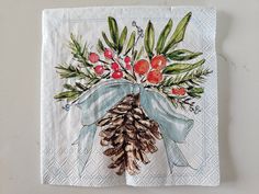 a napkin with pine cones and berries on it