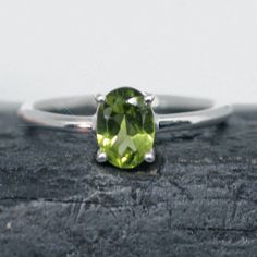 This ring is made from beautiful soft green Peridot which has beautiful sparkling lemony mint green hues. It is size 5.5. The rectangular faceted gemstone is 5 mm mm x 7 mm and is prong set in sterling silver.  Your sterling silver ring will be shipped gift boxed with a jewelry card listing gemstones and metal used. Green Peridot Birthstone Ring For May, Classic Peridot Green Rings, Green Peridot Solitaire Birthstone Ring, Classic Green Peridot Ring, Green Faceted Ring For Anniversary, Imperial Topaz, Green Hues, Jewelry Card, Green Peridot