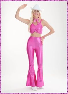 a woman in a pink outfit posing for a photo with her hands on her hips