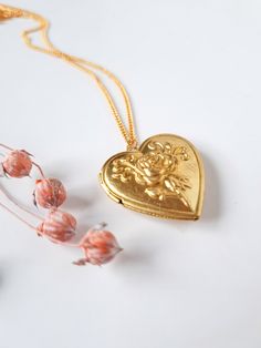 "Romantic vintage heart locket necklace for photo from 80s New Old Stock (unused) in 24K gold plated chain with a rose in raised design and have one flat lid inside for adding a picture. This charming N.O.S vintage locket is made of gold raw brass. A lovely piece for treating yourself or a beloved one. Lockets measure 29mm x 29mm x 7.5mm = 1.14\" x 1.14\" x . Gold plated chain is available in 20\" = 50cm and 24\" = 60cm DISCOUNTS and/or FREE SHIPPING adding other pieces to your order!: bit.ly/Ne Vintage Antique Gold Heart Pendant Necklace, Antique Gold Heart Pendant Vintage Necklace, Vintage Necklace For Valentine's Day, Vintage Rose Gold Locket Necklace For Gift, Vintage Rose Gold Locket Necklace Gift, Vintage Pendant Locket Necklace For Valentine's Day, Vintage Necklaces With Vintage Charm For Valentine's Day, Vintage Brass Necklace For Valentine's Day, Victorian Gold Jewelry For Anniversary Gift