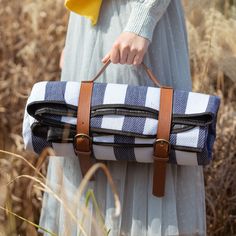 a woman carrying a blue and white checkered bag