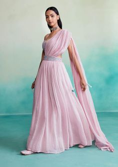 Introducing "bloomsy" - where elegance meets comfort! Our orchid pink bloomsy skirt saree is a one-of-a-kind creation, featuring a hand-embroidered bustier blouse adorned with mesmerizing double buttonhole stitches and shiny cutdanas. What sets this ensemble apart is its innovative design, allowing the dupatta to seamlessly attach to the skirt, granting you the look of a saree without the hassle of draping. Traditional Pink Draped Lehenga, Traditional Draped Pink Lehenga, Anarkali Draped Dress With Pallu, Elegant Draped Pink Lehenga, Floor-length Pink Choli For Evening, Pink Floor-length Evening Lehenga, Pink Floor-length Evening Choli, Evening Floor-length Pink Lehenga, Pink Floor-length Pre-draped Saree With Zari Work