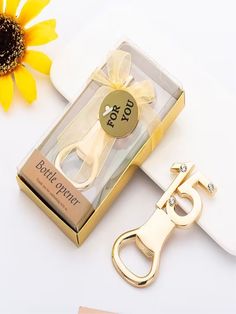 a pair of scissors sitting next to a box with a yellow flower on the side