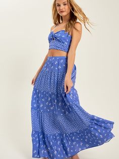 Featuring a captivating blend of floral prints and a flattering midi length, this skirt effortlessly embodies free-spirited vibes, making it a must-have for your everyday adventures. Spring Breezy Gathered Maxi Skirt, Bohemian Flowy Maxi Skirt For Spring, Bohemian Spring Maxi Skirt, Breezy Flowy Maxi Skirt For Day Out, Flowy Breezy Maxi Skirt For Day Out, Breezy Maxi Skirt For Day Out, Spring Tiered Maxi Skirt In Rayon, Vacation Tiered Rayon Skirt, Breezy Ruffled Maxi Skirt For Vacation