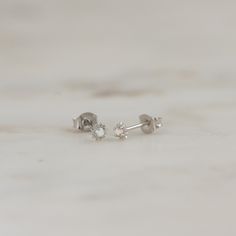 Such a cute, and dainty pair of earrings! They're perfect alone or stacked. They're a tiny pair that are perfect for second piercings, cartilage piercings, or for a minimalist touch. ✤✤ Details ✤✤ ☼ Made of 925 Sterling Silver ☾ We use a THICK plating of 14k Gold or Rhodium for a piece that is sure to last you years to come ★ Sold as a PAIR ☼ Nickel-free & Hypoallergenic ★ Measures 3.5 mm x 3.5 mm ☾ We use the highest grade of cubic zirconia for an authentic diamond look Comes in a cute gift Tiny Gold Studs, Huggie Earrings Gold, Small Gold Hoop Earrings, Opal Stud Earrings, Sun Earrings, Small Stud Earrings, Studs Gold, Minimalist Earrings Studs, Minimalist Studs