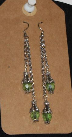 3" silver chain dangle earings with green crystal dangles Green Crystal Drop Earrings With Dangling Beads, Green Dangle Crystal Earrings, Green Dangling Charms Jewelry, Green Dangle Jewelry With Dangling Charms, Green Dangle Jewelry With Charms, Green Crystal Earrings For Jewelry Making, Green Nickel Free Dangle Chandelier Earrings, Green Nickel-free Dangle Chandelier Earrings, Dangle Earrings With May Birthstone In Metal