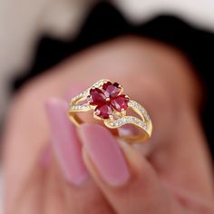 Product Details Dazzling Flower Engagement Ring is a mesmerizing piece set with Heart Shape Ruby stone in a flower design in the center. The spiral shank is encased with Round Shape Diamond in the prong setting. This Statement Ring is crafted in Solid Gold, a wonderful accessory for parties or weddings. Product Information SKU SHP-RINGS082019889 Width 2.5 mm Height 11 mm Weight 2.21 gm (Approximate) RUBY INFORMATION No.of Stones 4 Pieces Total Weight 1.88 Carat (Approximate) Dimension(approx) He 4 Petal Flower, Ruby Flower, Bypass Engagement Ring, Flower Engagement, Ruby And Diamond Ring, Floral Engagement Ring, Flower Engagement Ring, Ruby Stone, 18k Yellow Gold Ring