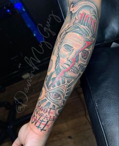 a man's arm with a tattoo on it and a skull in the middle