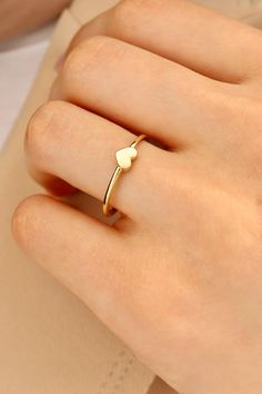 14K Gold Minimalist Heart Ring - Delicate and Elegant Heart-Shaped Design. Simple and Elegant Minimalist Jewelry Step into a world of elegance with our 14K Gold Minimalist Heart Ring. This delicate piece is meticulously crafted to perfection, featuring a charming heart-shaped design that exudes simplicity and grace. The minimalist style makes it a versatile accessory, perfect for both special occasions and everyday wear. Our 14K Gold Minimalist Heart Ring is more than just a piece of jewelry; it's a timeless statement of love and elegance. The sleek gold band beautifully complements the understated heart shape, offering a harmonious blend of modern sophistication and classic charm. Whether you're looking to treat yourself or find the perfect gift for a loved one, this ring is the ideal cho Simple Gold Rings Everyday, Gold Rings Simple, Signet Rings, Delicate Rings, Design Simple, Signet Ring, Minimalist Style, Minimalist Jewelry, Gold Bands