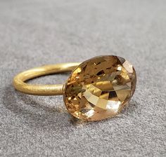 1. Drilled 14k Gold Champagne Quartz Ring 2. Resizable 3. Gemstone - Champagne Quartz 4. Jewelry Type - Gold Ring 5. Total weight - 4.160 Gram Approx.  6. Quartz Weight - 9.20 Carats  7. Gold Weight - 2.320 Grams Approx.  8. Quartz Size - 12x16 MM 9. Gold Purity - 14k 10. Handmade Items 11. Band Size - 2 MM 12. Oval Shape 13. AAA Quality 14. Half Drilled  15. 1 Quantity Available 16. Ready to Dispatch in 1 - 2 days.  Pictures are taken under natural and day light. Oval Gold Topaz Ring With Diamond Cut, Gold Oval Ring With Large Stone, Timeless Gold Oval Topaz Ring, Yellow Gold Oval Jewelry With Large Stone, Timeless Oval Gold Topaz Ring, Oval Faceted Rings In Fine Jewelry Style, Elegant Oval Topaz Ring With Large Stone, Oval Yellow Gold Topaz Gemstone Ring, Yellow Gold Rings With Large Stone For Wedding