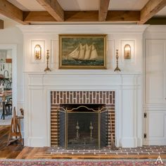 a living room with a fire place and a painting on the wall above it's mantle