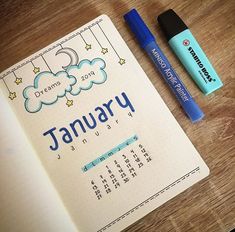 a calendar, pen and eraser sitting on a table next to a notebook with the word january written in it