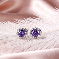 Sparkling and elegant, these purple stud earrings are perfect for that special evening out. Created in sterling silver, each earring features a round cut stone sparking at its center, while additional round stones line the sterling silver settings for extra shimmer. An imaginative look you'll adore, these earrings are unsurpassed with magnificence and sparkle.Carat Weight: 7.2 ctStone Size: 8 mmStone Type: Jeulia® StoneNumber of Stones: 2 Stone Color: Amethyst PurpleStone Shape: RoundCarat Weigh Formal Lavender Earrings, Elegant Purple Earrings For Pierced Ears, Elegant Purple Cubic Zirconia Crystal Earrings, Elegant Purple Drop Crystal Earrings, Elegant Purple Drop Earrings, Elegant Purple Pierced Earrings, Lavender Fine Jewelry Earrings For Formal Occasions, Purple Pierced Earrings For Wedding, Pierced Amethyst Crystal Earrings