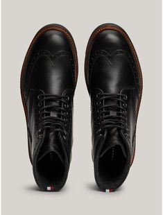 Tommy Hilfiger men's boot. Traditional brogue detailing lends a stylish touch to these lace-up boots, while warm linings and water-repellent leather make them ideal for tran-seasonal wear.  Material: 100% Leather (fwa). Casual Wingtip Lace-up Boots With Rubber Sole, Formal Wingtip Lace-up Boots For Winter, Winter Formal Lace-up Boots With Brogue Detailing, Goodyear Welted Lace-up Boots For Business In Winter, Business Lace-up Boots With Goodyear Welt For Winter, Winter Business Lace-up Boots With Goodyear Welt, Classic Wingtip Lace-up Boots For Winter, Winter Business Lace-up Boots With Brogue Detailing, Winter Cap Toe Lace-up Boots With Brogue Detailing