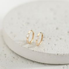 Fall in love with these unique 14k gold hoop earrings for little girls. These stunning hoop earrings feature a beautiful baguette cut cubic zirconia stone at its center and are easy to pair with your little girls favorite accessories and outfits. Finely crafted from 14k yellow gold, these earrings are a beautiful and safe option for young girls who have sensitive ears. Packed in a cute gift box for easy gifting. 14k Gold Hoop Earrings, Cute Gift Boxes, Baguette Cut, Girls Earrings, Cute Gift, Sensitive Ears, Gold Hoop, Gold Hoop Earrings, Girls Shopping