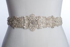 "wedding sash, wedding dress sash, beaded Bridal sash, rhinestone wedding belt, crystal bridal belt, rhinestone bridal belt SOLANGE hand beaded and feature lot of stunning clear and ivory glass beads, crystal and clear rhinestones and ivory silk petals, Hand beaded, high end finished, attached to a luxurious satin ribbon much more beautiful in person, this piece can be attached directly to the dress 92 inch sash 1 1/2 inches wide satin ribbon in the color of your choice gorgeous hand beaded appl Elegant Bedazzled Bridal Belt For Wedding, Elegant Bedazzled Wedding Sash, Silver Bedazzled Bridal Belt For Wedding, Bedazzled White Bridal Belt For Wedding, Bedazzled Crystal Bridal Belt For Wedding, Crystal Bedazzled Bridal Belt For Wedding, Elegant Crystal Wedding Sashes, Fitted Rhinestone Bridal Belt For Wedding, White Crystal Embellished Bridal Sash