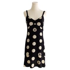 This vintage Chanel polka dot dress, an iconic piece from Karl Lagerfeld's 1997 Spring/Summer runway collection, has been famously worn by Rihanna. Crafted from luxurious black silk, it features the signature off-white polka dot design interspersed with the interlocking "CC" logo. The dress is designed with a slightly flared cut and a babydoll silhouette, complemented by a flattering V-neckline. In good condition with some minor stains on polka dots. Labeled in size FR42, I estimate it to comfor Chanel Little Black Dress, Vintage Chanel Dress, Spring Summer Runway, Silk Summer Dress, Summer Runway, Mongolian Lamb, 20th Century Fashion, Chanel Vintage, Round Neck Dresses