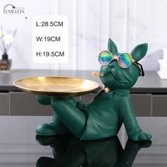 a small figurine is holding a tray on it's legs and wearing sunglasses