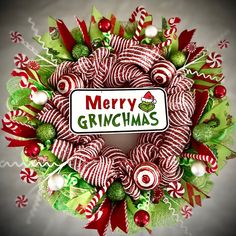 a christmas wreath with candy canes and candies around it that says merry grinmas