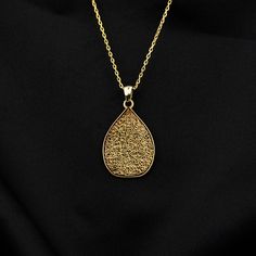 Crafted as a timeless piece of art, the Ayatul Kursi Islamic Necklace transcends mere adornment, embodying elegance and spirituality. This exquisite necklace features intricate Arabic calligraphy, delicately engraved to showcase the revered verses from the Quran. Made with 925 sterling silver and luxuriously gold plated, this pendant exudes a sense of divine beauty and grace. A perfect gift for the modern Muslim woman, this dainty necklace is a symbolic expression of faith and devotion. Whether it's a thoughtful present for your mother, a birthday gift for a friend, or a special gesture for yourself, this Islamic necklace is a meaningful addition to any jewelry collection. Graceful and meaningful, this necklace is a radiant reminder of Allah's presence, making it a cherished piece that res Elegant Silver Necklaces For Blessings, Elegant Silver Necklace For Blessing, Elegant Silver Necklace For Blessing Occasions, Traditional Teardrop Necklace For Gift, Traditional Teardrop Pendant Jewelry Gift, Elegant Teardrop Pendant Necklace For Meditation, Elegant Pendant Jewelry For Blessing, Amulet Necklace For Meditation With Intricate Design, Intricate Design Amulet Necklace For Meditation